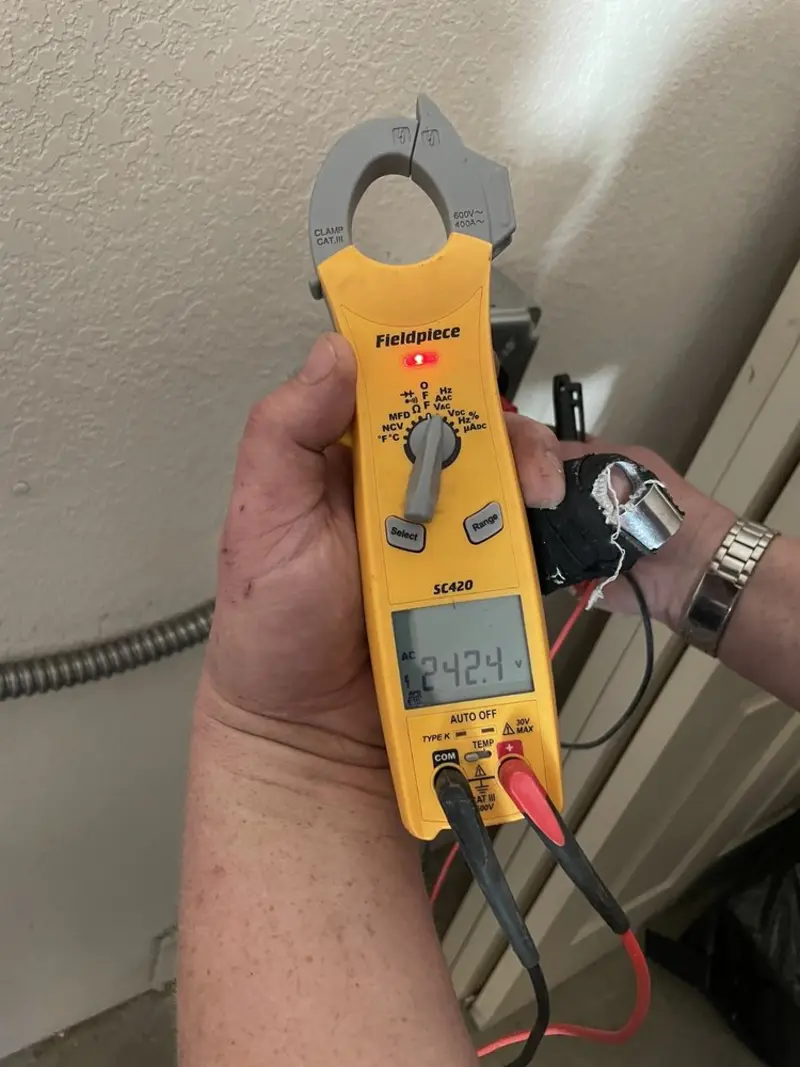 Voltage testing with clamp meter during Ceiling Fan Installation in Baldwyn